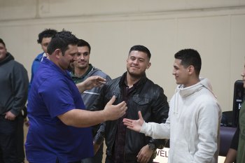 Marcio Botelho accepts congratulations from former standouts (Left to right) Adrian Marrufo and Angel Robles.